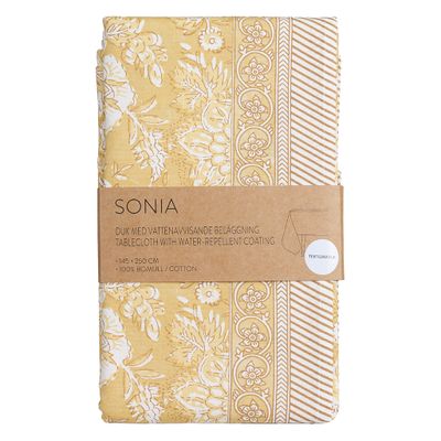 Sonia gul akrylatduk i bomull med dekorativt mönster, 140x250 cm