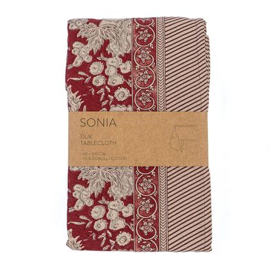 Hopvikt bordduk i röda och beige toner med blommönster.