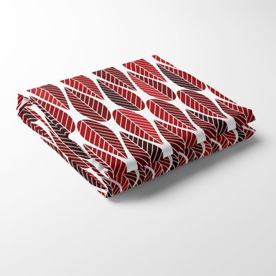 Blader röd duk är en modern bordsduk med ett stiliserat bladmotiv i varma röda toner.