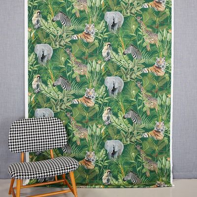 Djungel curtains and decorative fabrics with print of wild animals and the jungle on a green bottom sold by the meter online at nordictextiles.com.
