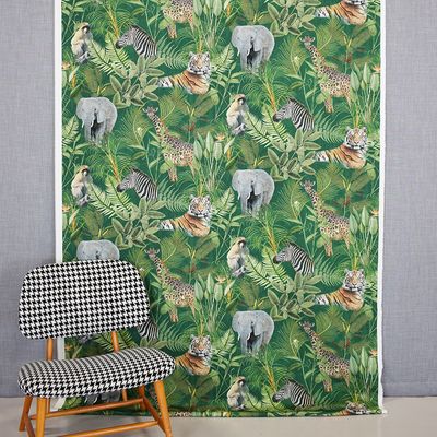 Djungel curtains and decorative fabrics with print of wild animals and the jungle on a green bottom sold by the meter online at nordictextiles.com.