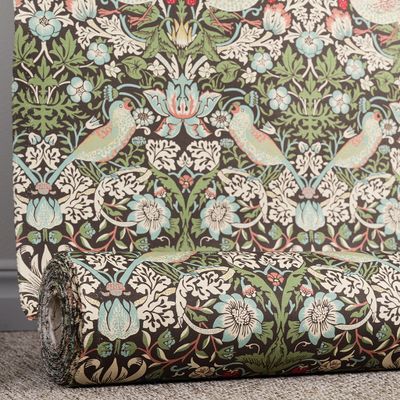 Tyg rullat på rulle med klassiskt mönster i grönt och blått