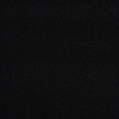 Närbild av svart möbeltyg med mjuk fårpälsliknande struktur