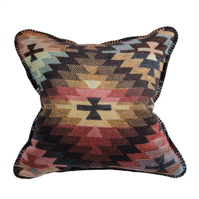 Kuddfodral med grafiskt ikatmönster i orange, turkos och bruna toner