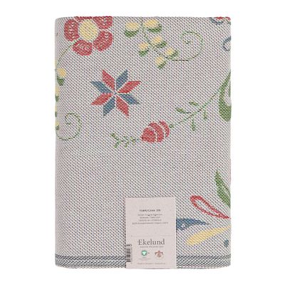 Vikt Torplycka bordsduk från Ekelunds Linneväveri med flerfärgat blommönster på beige botten och produktetikett.