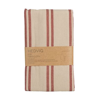 Vikt bordsduk Hedvig i beige med vävda röda ränder och pappersband runt förpackningen.