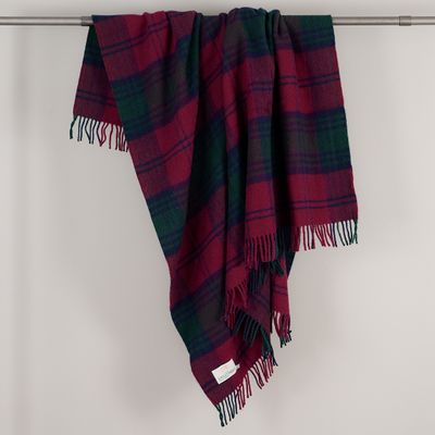 Ullpläd Lindsay från Tweedmill draperad över en stång, med stora vinröda och mörkgröna rutor och fransar